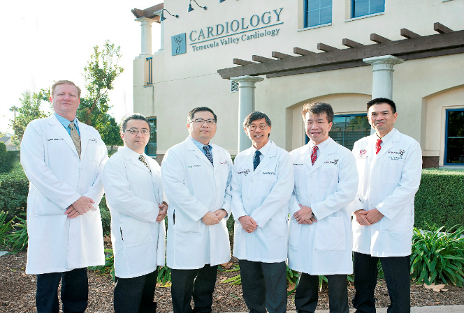 A group of doctors standing in front of a building.