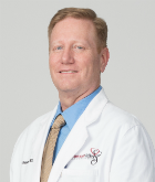 A man in white lab coat and tie.